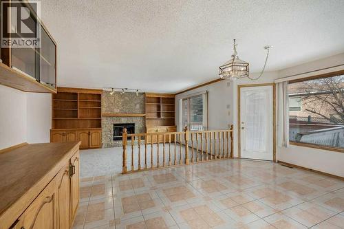 Breakfast Nook - 106 Sienna Hills Drive Sw, Calgary, AB - Indoor Photo Showing Other Room With Fireplace