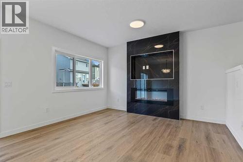 90 Heritage Circle, Cochrane, AB - Indoor With Fireplace