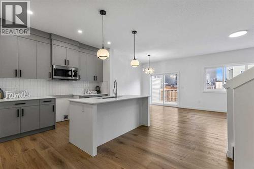 90 Heritage Circle, Cochrane, AB - Indoor Photo Showing Kitchen With Upgraded Kitchen