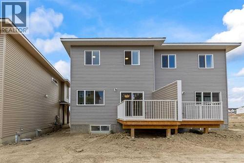 90 Heritage Circle, Cochrane, AB - Outdoor With Deck Patio Veranda With Exterior