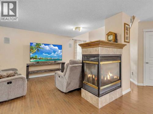 3-Sided Fireplace - 60 Sherwood Way Nw, Calgary, AB - Indoor Photo Showing Living Room With Fireplace