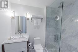 Bathroom with Marble and Glass Shower - 