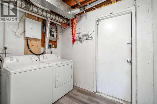 Access to the attached oversized single garage from the lower unit - 39 Bermuda Drive, Calgary, AB - Indoor Photo Showing Laundry Room