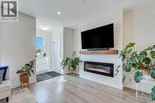 145 Lucas Crescent Nw, Calgary, AB - Indoor Photo Showing Living Room With Fireplace