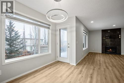 104 Cove Crescent, Chestermere, AB - Indoor Photo Showing Other Room With Fireplace