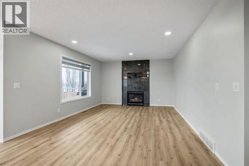 104 Cove Crescent, Chestermere, AB - Indoor Photo Showing Other Room With Fireplace
