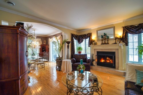 Living Room - 10625 Boul. Des Mille-Îles, Laval (Saint-François), QC - Indoor Photo Showing Living Room With Fireplace
