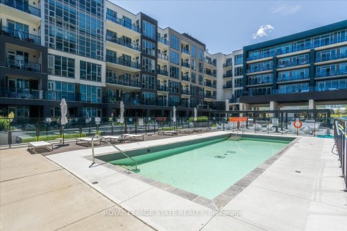 150-16 Concord Place, Grimsby, ON - Outdoor With In Ground Pool With Facade