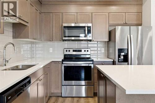 208, 30 Shawnee Common Sw, Calgary, AB - Indoor Photo Showing Kitchen With Stainless Steel Kitchen With Double Sink With Upgraded Kitchen