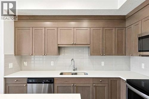208, 30 Shawnee Common Sw, Calgary, AB - Indoor Photo Showing Kitchen With Stainless Steel Kitchen With Double Sink