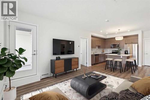 208, 30 Shawnee Common Sw, Calgary, AB - Indoor Photo Showing Living Room