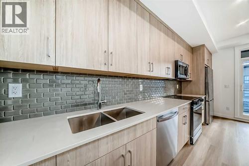 7320, 1802 Mahogany Boulevard Se, Calgary, AB - Indoor Photo Showing Kitchen With Stainless Steel Kitchen With Double Sink With Upgraded Kitchen