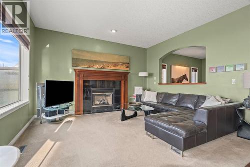 153 Crestridge Way Sw, Calgary, AB - Indoor Photo Showing Living Room With Fireplace