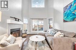 Living room with fireplace multiple windows facing west - 