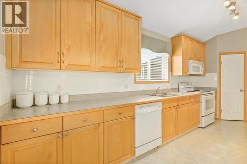 131 Panatella Close Nw, Calgary, AB - Indoor Photo Showing Kitchen With Double Sink