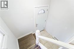 Foyer featuring baseboard heating and wood finished floors - 