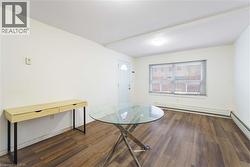Dining space featuring dark wood finished floors, baseboard heating, and a baseboard radiator - 