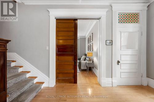Wood sliding doors lead to the living room. - 553 Gilmour Street, Ottawa, ON - Indoor Photo Showing Other Room