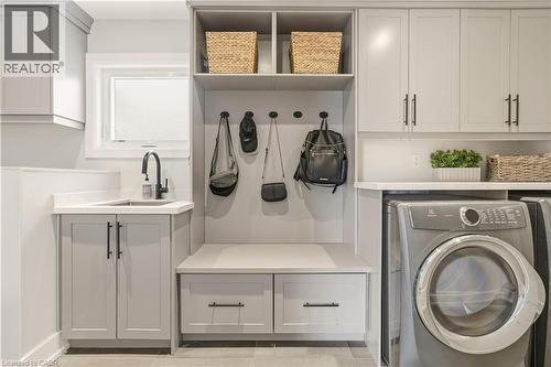 Laundry area with washer / clothes dryer and cabinet space - 697 Lambshead Drive, Burlington, ON - Indoor Photo Showing Laundry Room