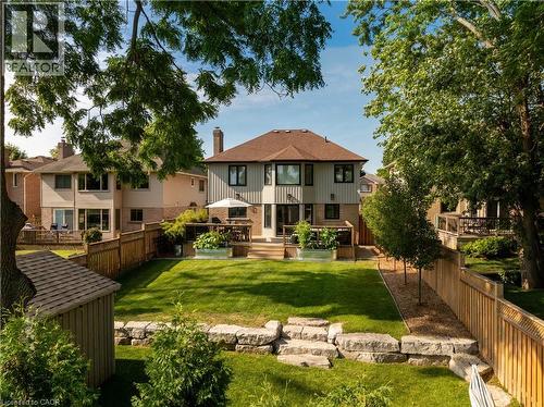 Back of property featuring a fenced backyard, a wooden deck, and brick siding - 697 Lambshead Drive, Burlington, ON - Outdoor With Deck Patio Veranda With Backyard