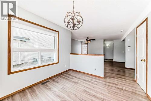 Large venting window and modern lighting in dining room - 21 Hillview Road, Strathmore, AB - Indoor Photo Showing Other Room