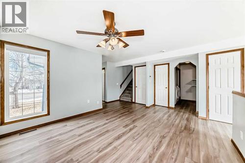 Off living room are the stairs to upper level, laundry room and half bath - 21 Hillview Road, Strathmore, AB - Indoor Photo Showing Other Room