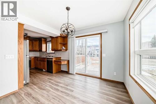 Dining room with the sliding glass doors to large deck and fenced back yard - 21 Hillview Road, Strathmore, AB - Indoor