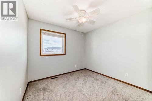 Bedroom 2 with big window - 21 Hillview Road, Strathmore, AB - Indoor Photo Showing Other Room