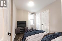 Bedroom featuring dark wood-type flooring and baseboards - 