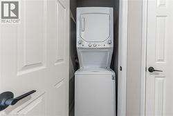 Laundry room featuring stacked washer and clothes dryer - 