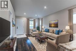 Living area featuring hardwood / wood-style flooring and recessed lighting - 