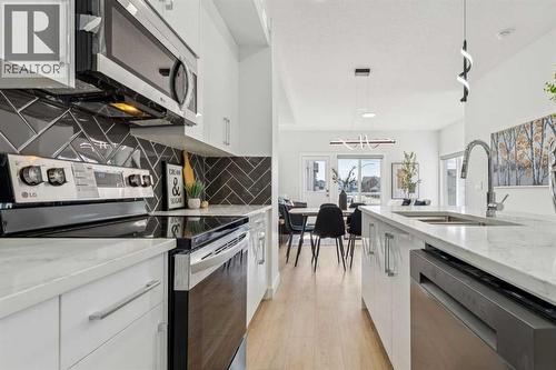 205, 95 Saddlecrest Circle Ne, Calgary, AB - Indoor Photo Showing Kitchen With Double Sink With Upgraded Kitchen