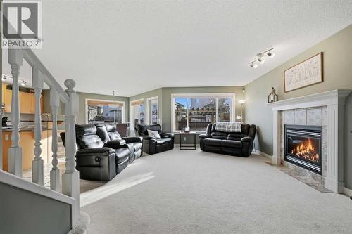 291 Springmere Link Sw, Chestermere, AB - Indoor Photo Showing Living Room With Fireplace