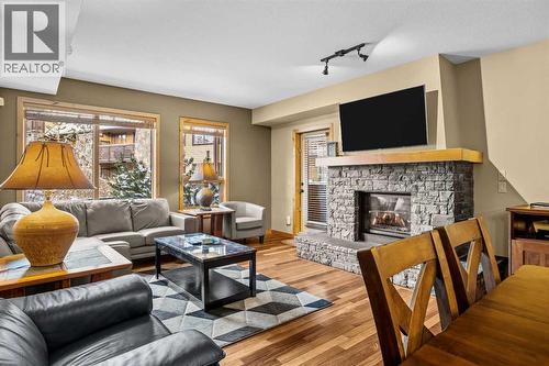 112, 379 Spring Creek Drive, Canmore, AB - Indoor Photo Showing Living Room With Fireplace