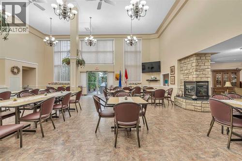 3340, 6818 Pinecliff Grove Ne, Calgary, AB - Indoor Photo Showing Dining Room With Fireplace
