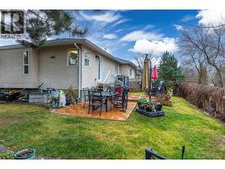 BACK YARD - Generous sized fenced back yard with wooden deck and lawn. - 