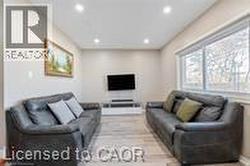 Living room featuring recessed lighting and light wood-style flooring - 