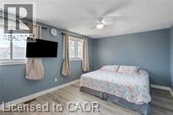 Bedroom with baseboards, wood finished floors, and ceiling fan - 