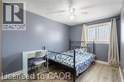 Bedroom featuring wood finished floors, baseboards, and ceiling fan - 