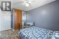 Bedroom with wood finished floors and ceiling fan - 