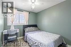 Bedroom with ceiling fan and wood finished floors - 