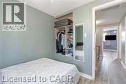 Bedroom featuring wood finished floors and baseboards - 