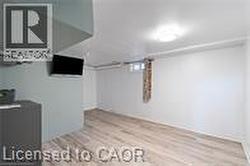 Additional living space featuring wood finished floors - 