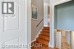 Stairs with wood finished floors and baseboards - 