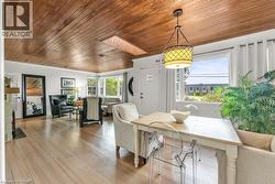 Dining room with wooden ceiling, wood-flooring, a skylight - 