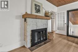Detailed view of wooden ceiling, a fireplace, and wood floors - 
