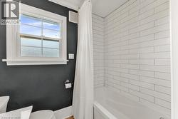 Full bath with toilet and shower / bathtub combination with curtain - 