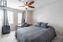 Bedroom with brand new light carpet, ceiling fan, and large windows for the best view! - 