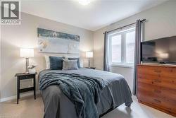 Bedroom featuring brand new light colored carpet and large window. - 