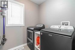 Washroom featuring baseboards and separate washer and dryer - 